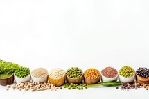 various legumes in wooden bowls and spoons on white background