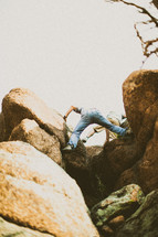 Two men climbing rocks.