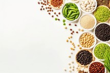 Assortment of beans on white background. Top view with copy space