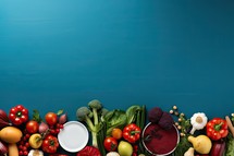 Fresh vegetables on blue background with copy space. Healthy food concept.