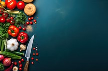 Fresh vegetables and knife on dark background. Top view with copy space