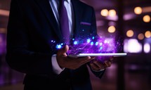 Businessman holding tablet with abstract glowing connection lines and dots on dark background