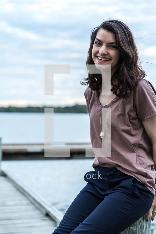 smiling teen girl on a dock 
