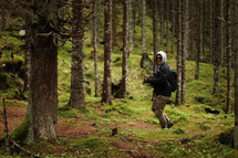 man hiking in a mountain forest 
