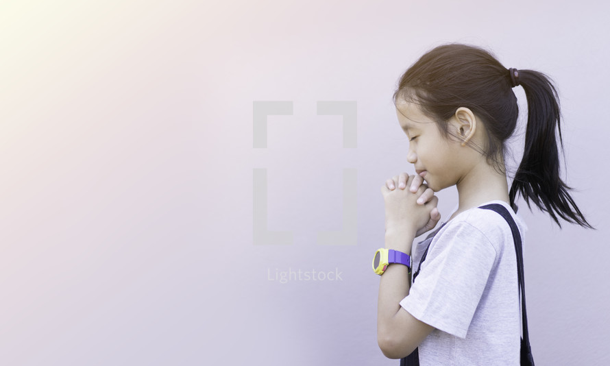a girl with praying hands 