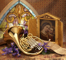 a french horn and painting of Mary and baby Jesus 