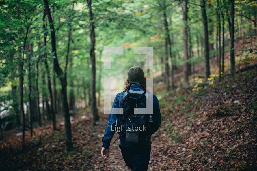 a man hiking through a forest 