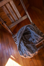 Woollen scarf lying on wooden chair