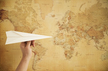paper airplane and world map 