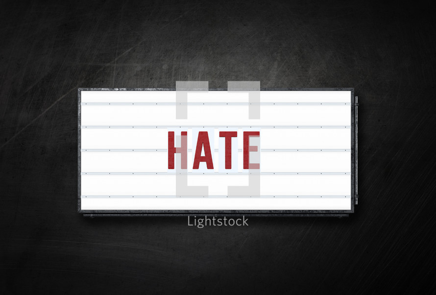 The word hate on a backlit sign.