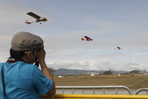 man taking pictures at an air show 