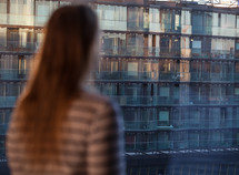 Woman looking at an apartment block
