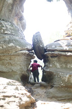 a boy exploring a cave 