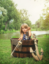 a child in a barrel pretending its a boat