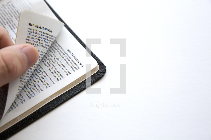 hand on a Bible turning pages.