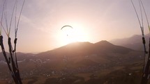 Beauty of evening paragliding flight to the sun at spring sunset, Freedom of Adrenaline adventure flying
