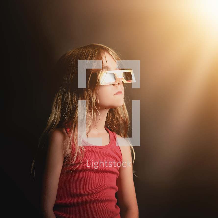 child wearing solar eclipse glasses 