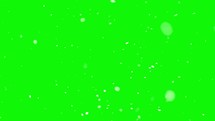 Real snow falls in winter season, It is snowing isolated on green screen background, blend as foreground layer
