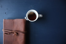coffee mug and leather bound Bible 
