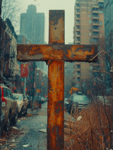 Old rusty cross on a street under the rain