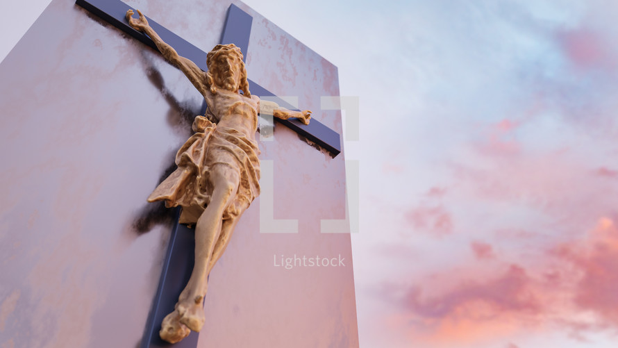 crucifix on the side of a church and clouds at sunset 