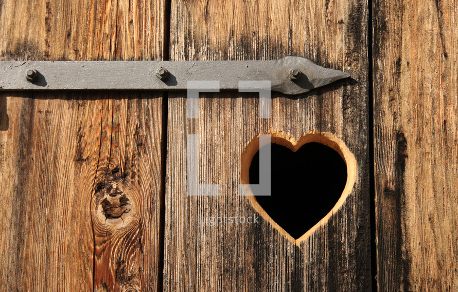 heart shape carved into wood door 
