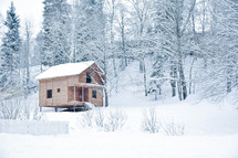 hut in a snowy forest