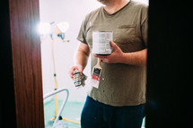 a man holding a paint can and paint brush 