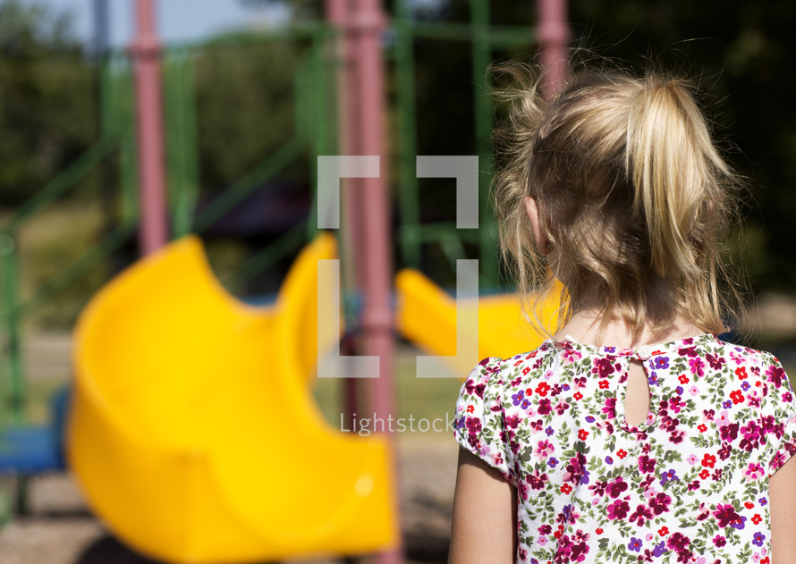 a girl approaching a playground 