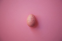 pink speckled Easter egg on pink background 
