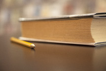 pencil and book on a desk. 