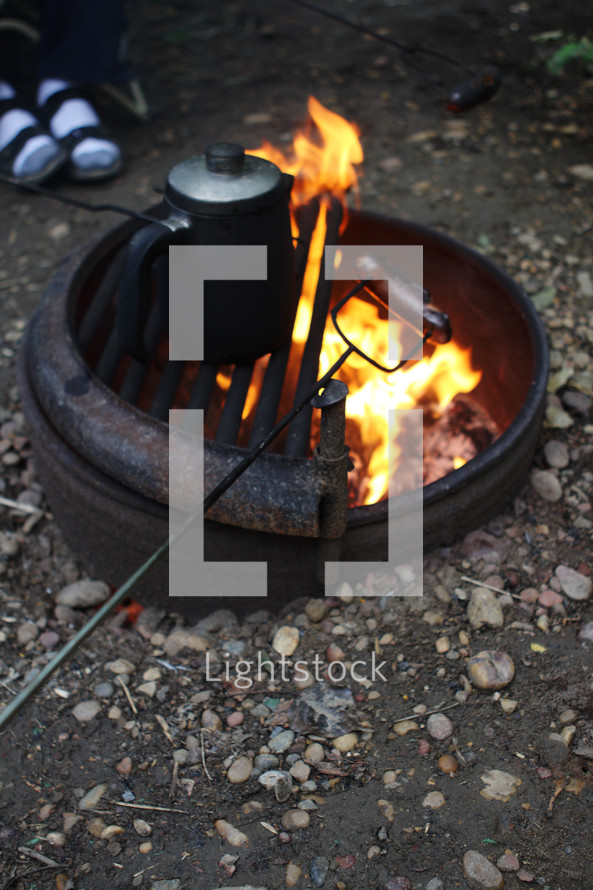 roasting hotdogs over a fire