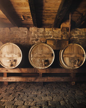 wooden wine barrels in a wine cellar 