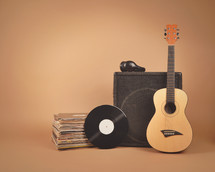 speaker, acoustic guitar, records, and headphones 
