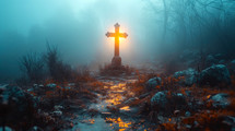 Cross on the rock. Cross with a warm light in a cold, foggy morning.