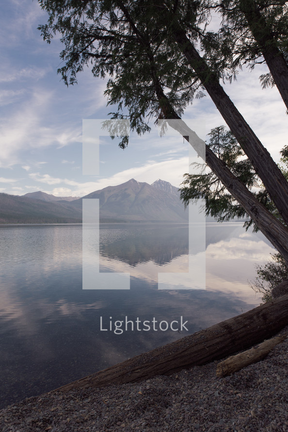 reflection of mountain peaks on lake water 