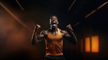 Black sportsman in orange tank top celebrating victory