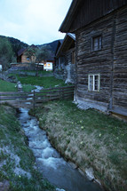 stream beside a cabin 