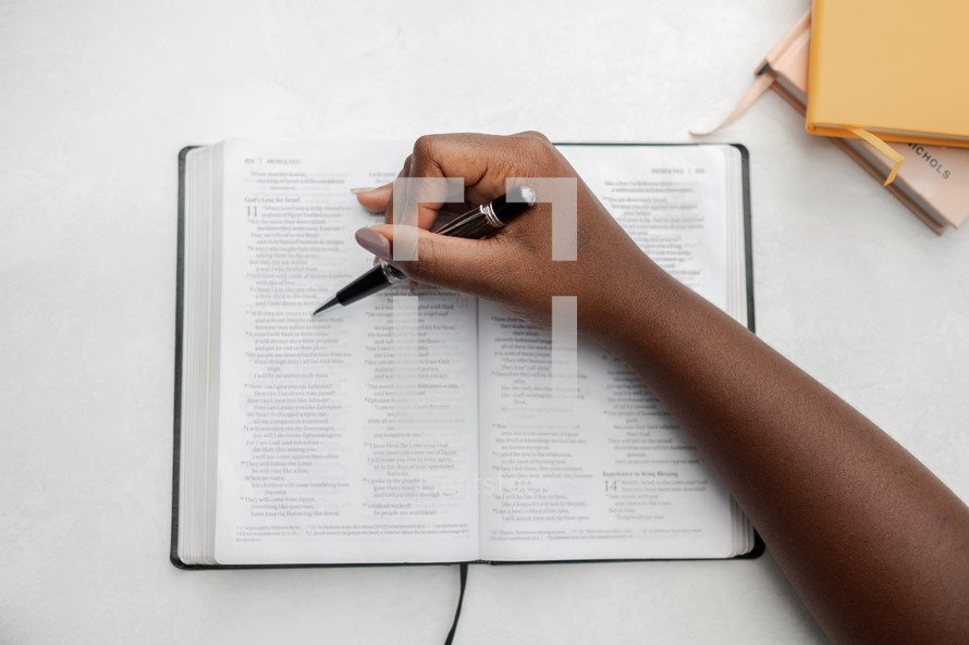 a woman reading a Bible and underlining scripture 