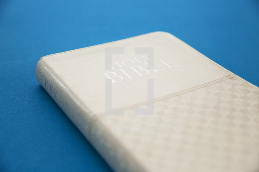 a Holy Bible with a white cover 