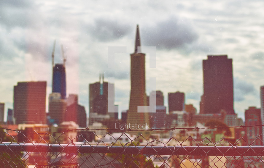 City beyond a fence