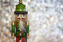 Traditional Wooden Soldier Christmas Nutcracker on a Sparkling Bokeh Background