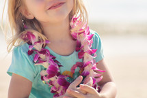 a girl child wearing an Hawaiian Leis