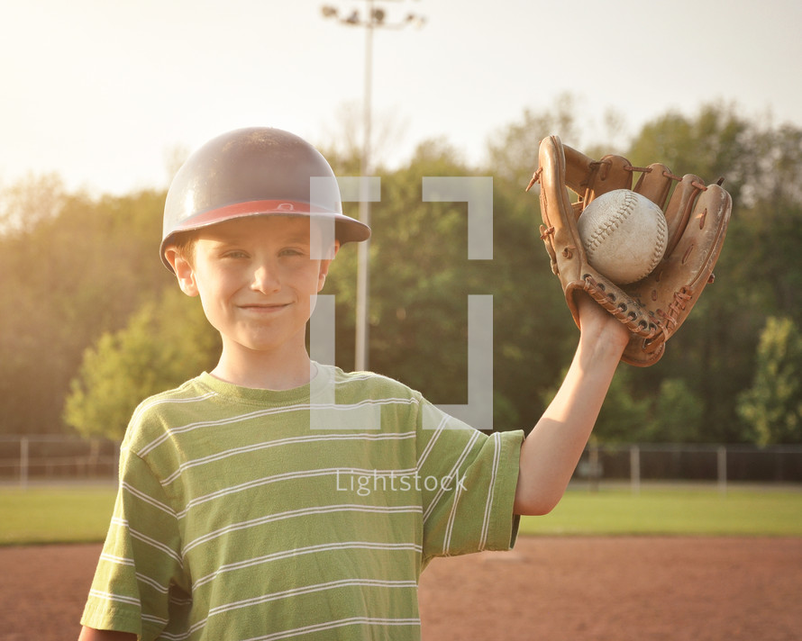 a child with a ball in his glove