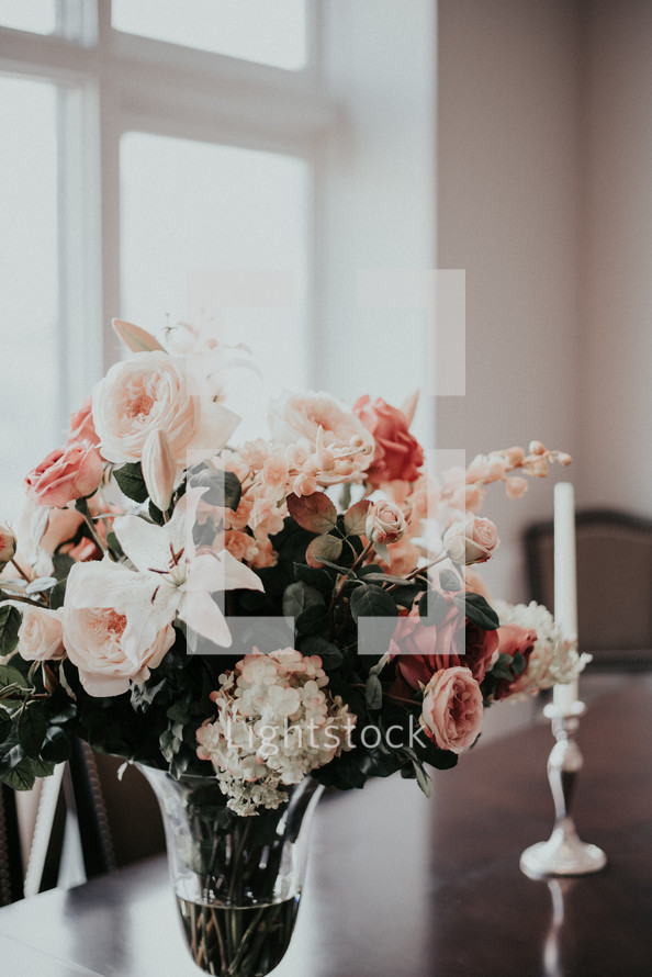 flower arrangement and candles on a table 