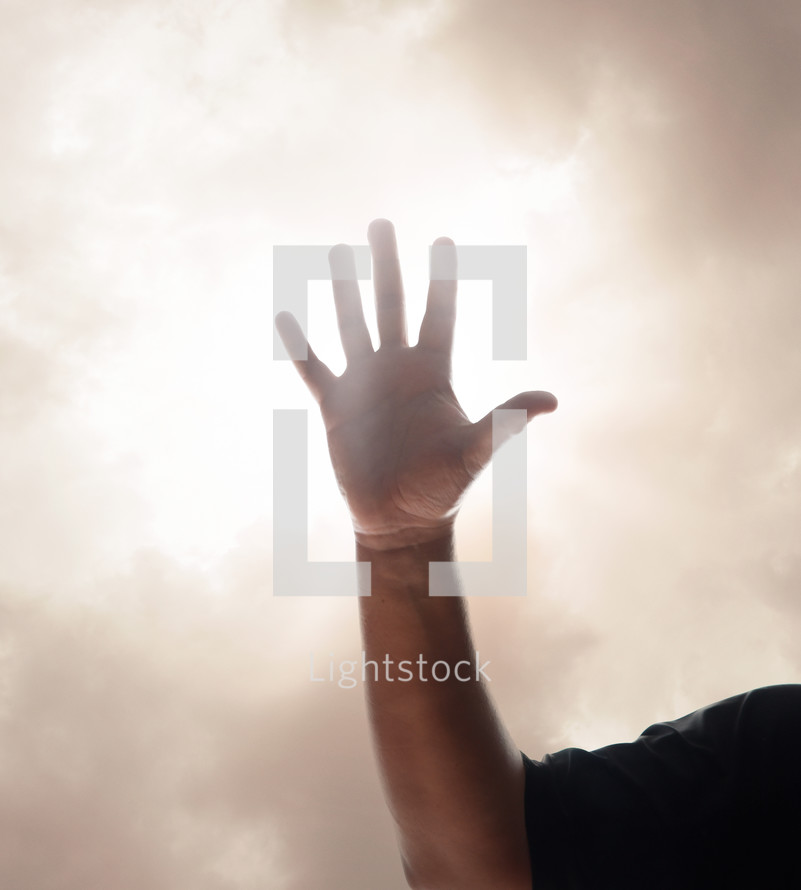 raised hand in a smoky sky 
