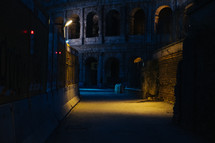 view of the Coliseum in Rome from a dark alley 
