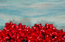 red bows on a blue wood background 