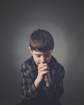 a boy child praying 