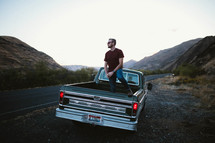 a man standing in a truck bed